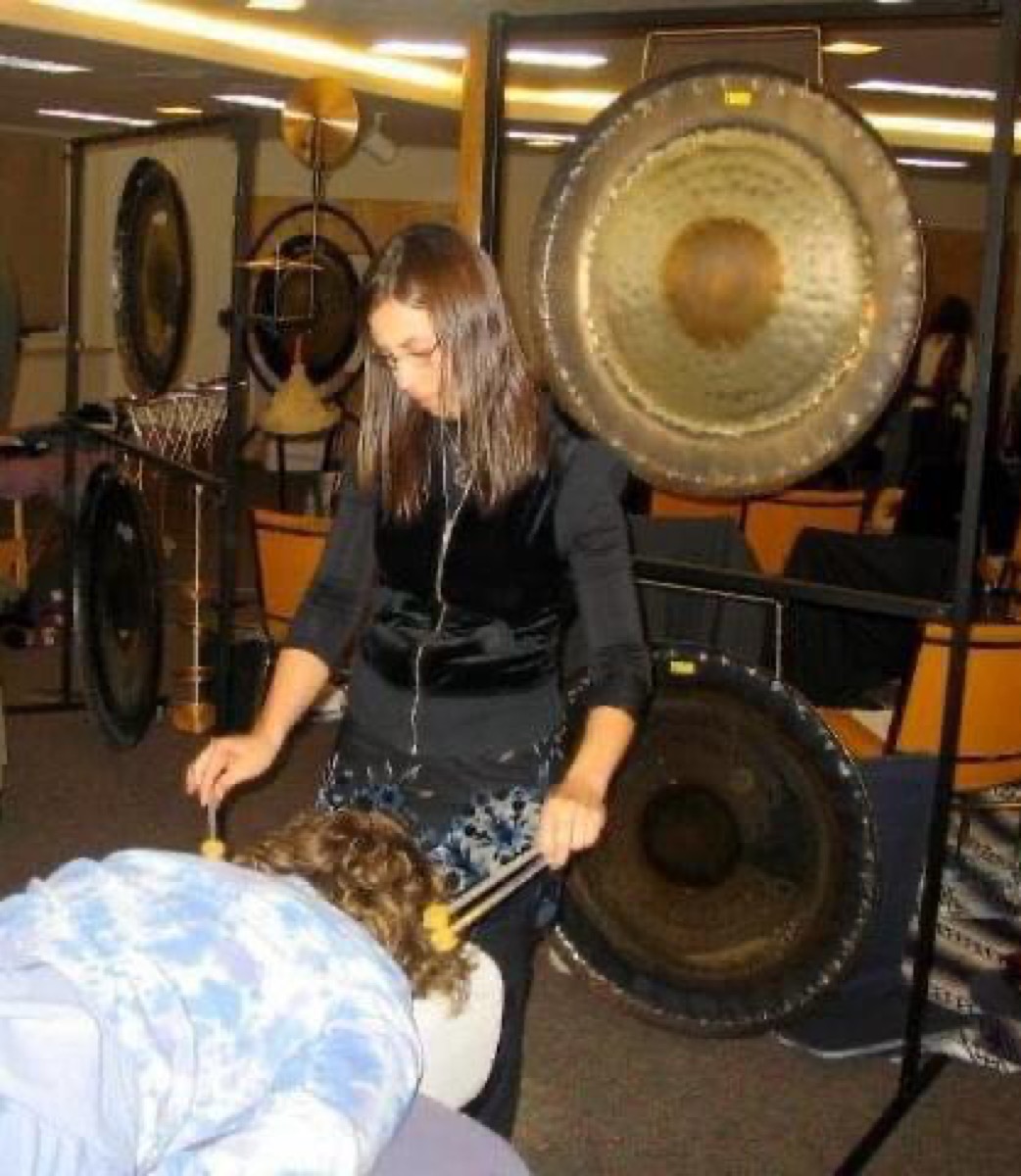 Sound healing practitioner applying Ohm tuning forks