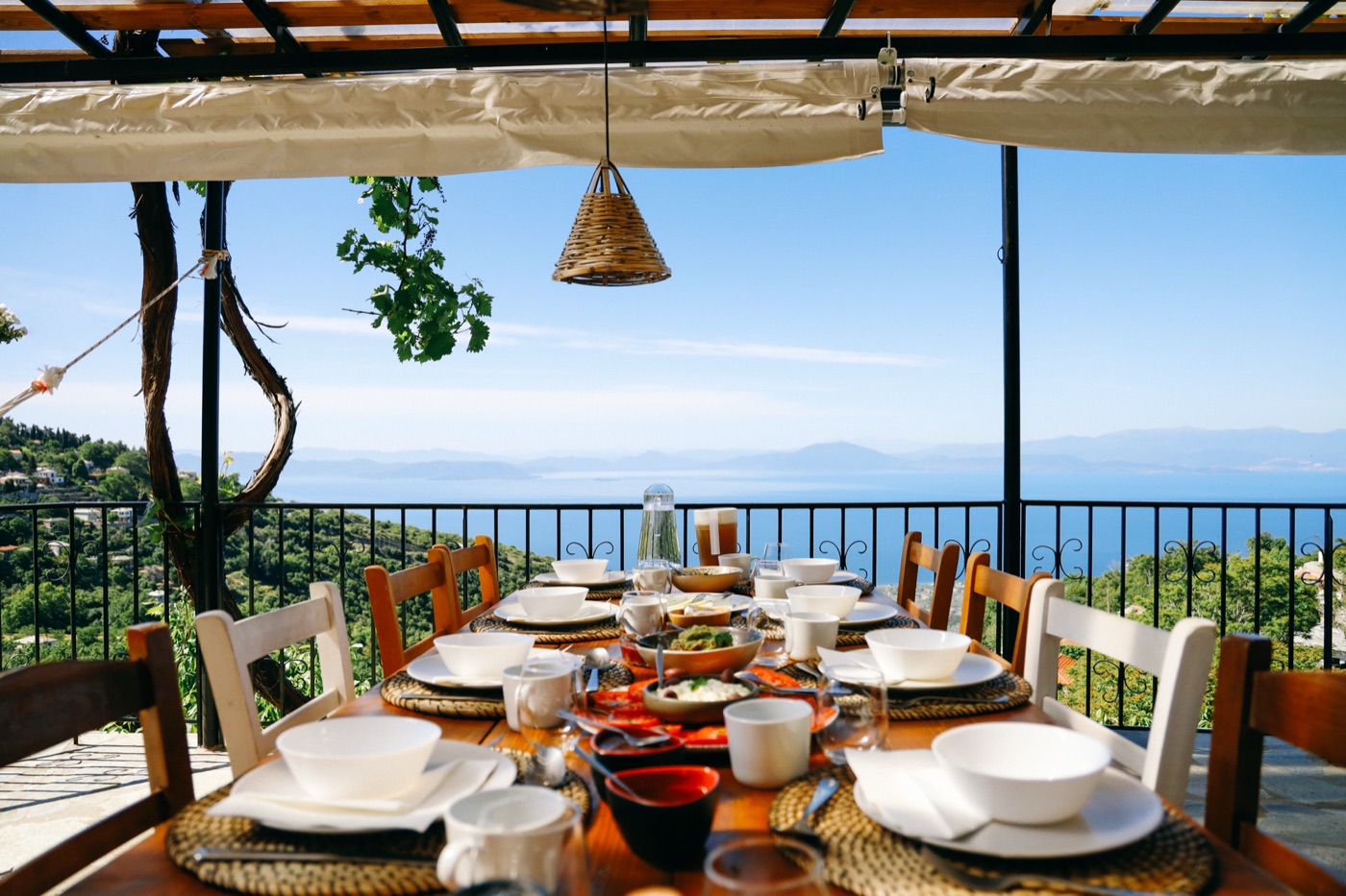 Al fresco dining table with views over the Aegean Sea