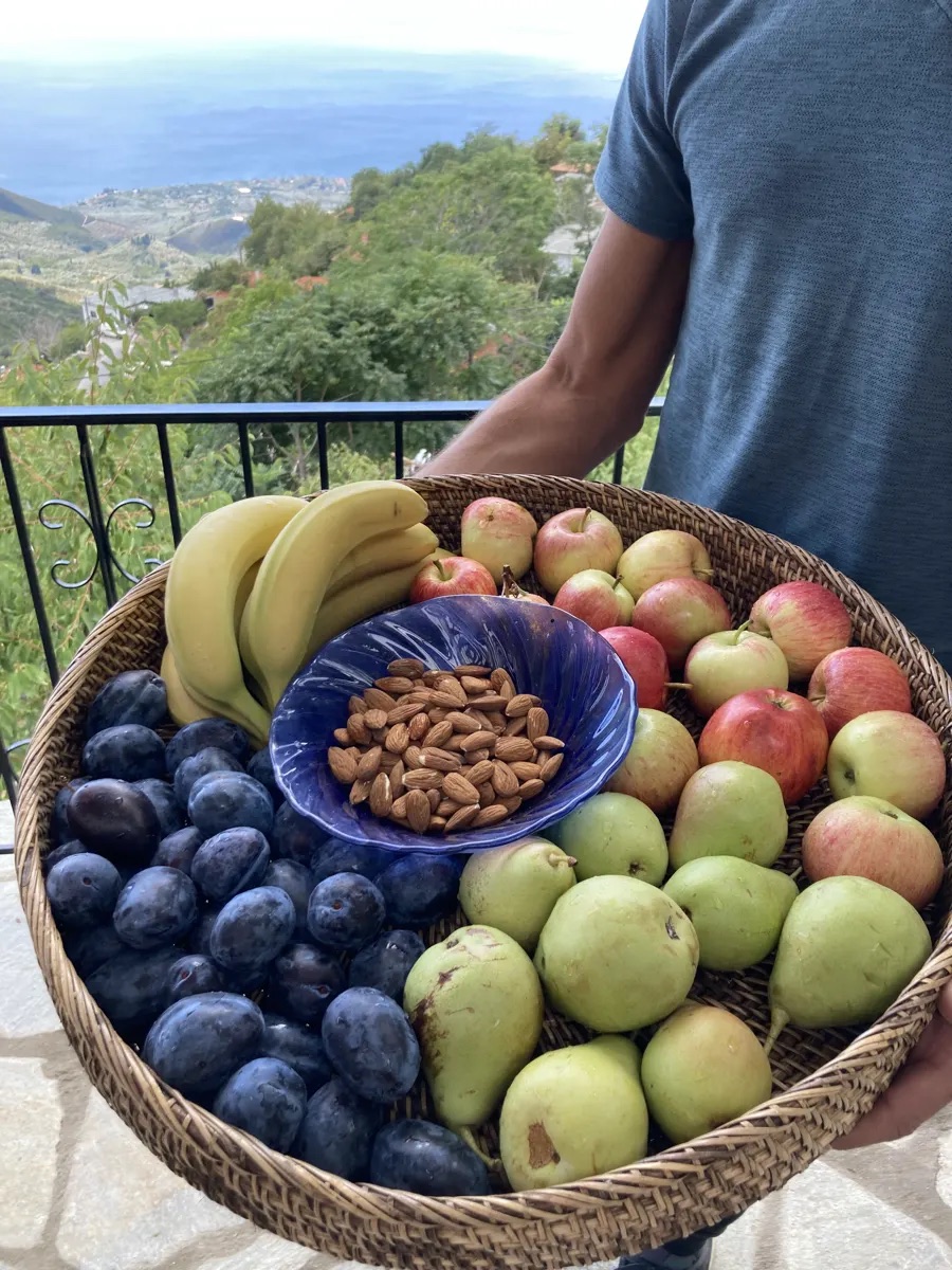 Basket of fresh local fruit and almonds with mountain views
