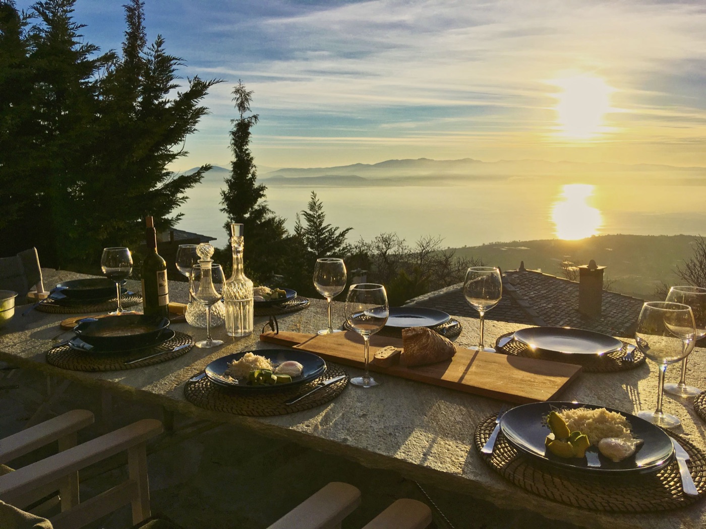 Dinner table set at sunset overlooking the Pagasitikos Gulf