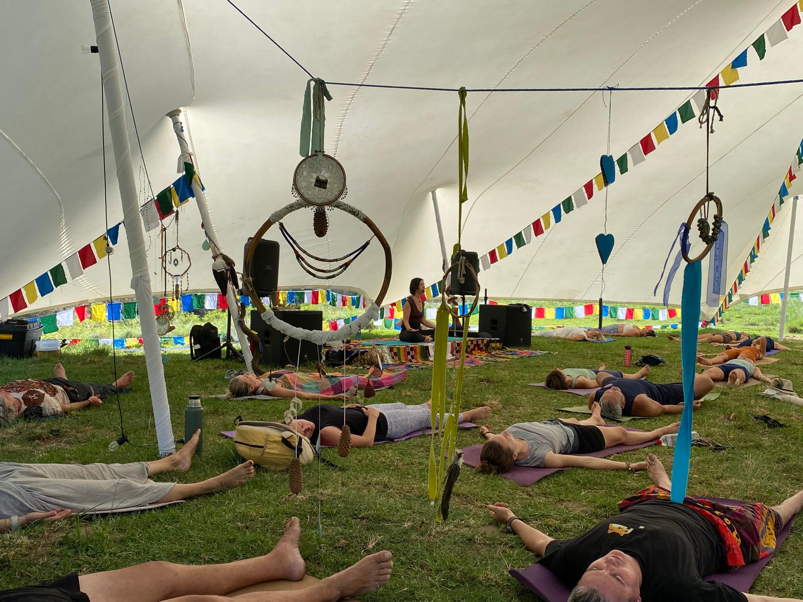 Yoga nidra under the tent with dreamcatchers and prayer flags